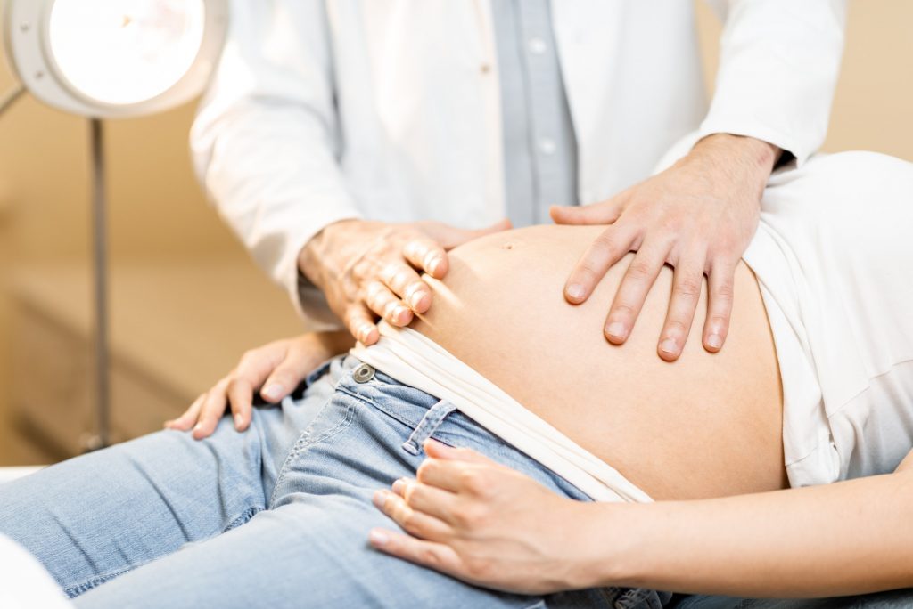 Medical massage of the abdomen of pregnant woman during an examination