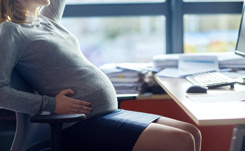 pregnant businesswoman sitting at office